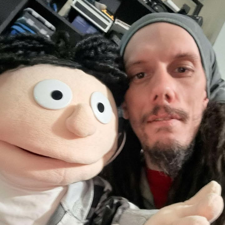 Person with a puppet in an indoor setting