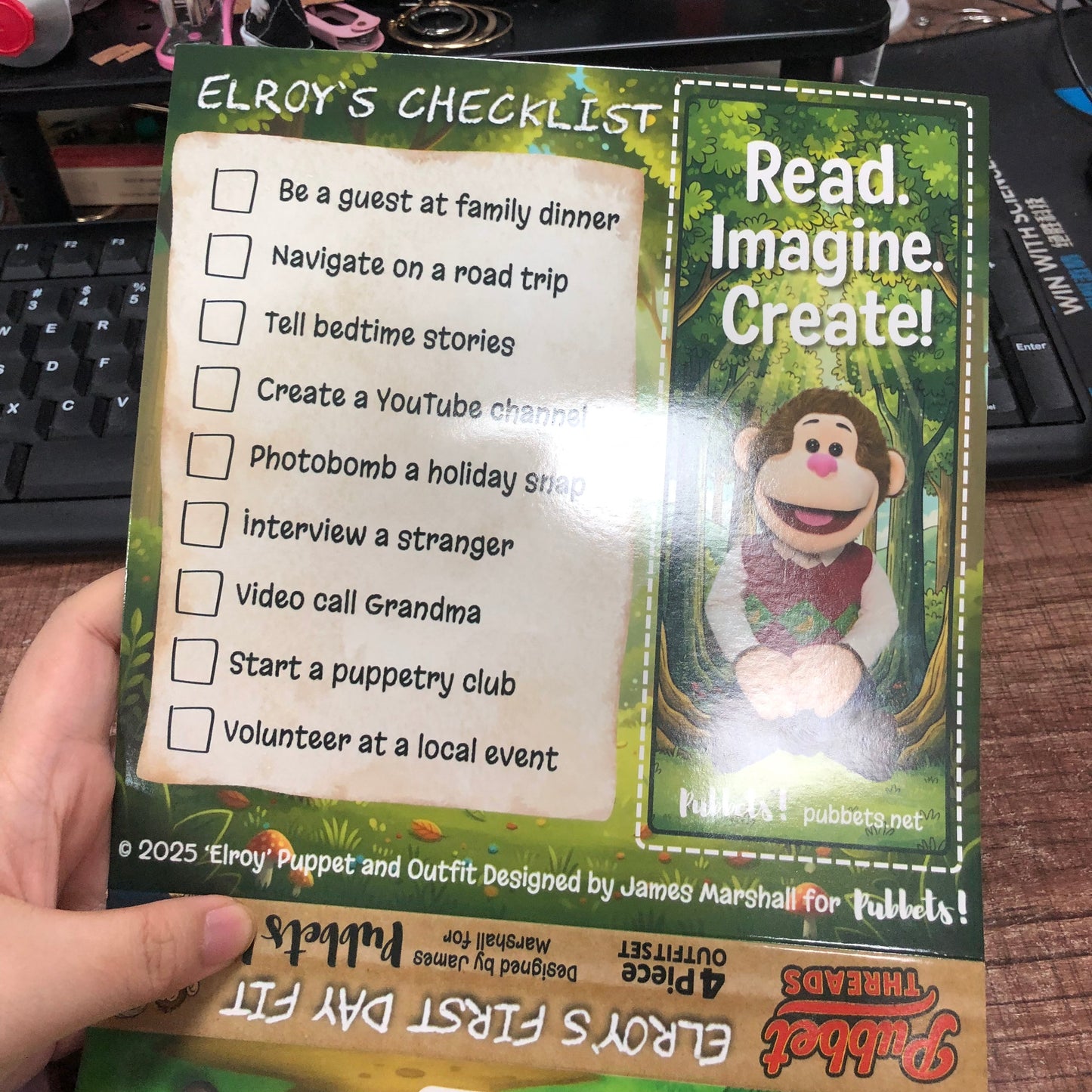Hand holding a checklist and book titled 'Read Imagine Create!' with Pubbets Puppet Company branding.